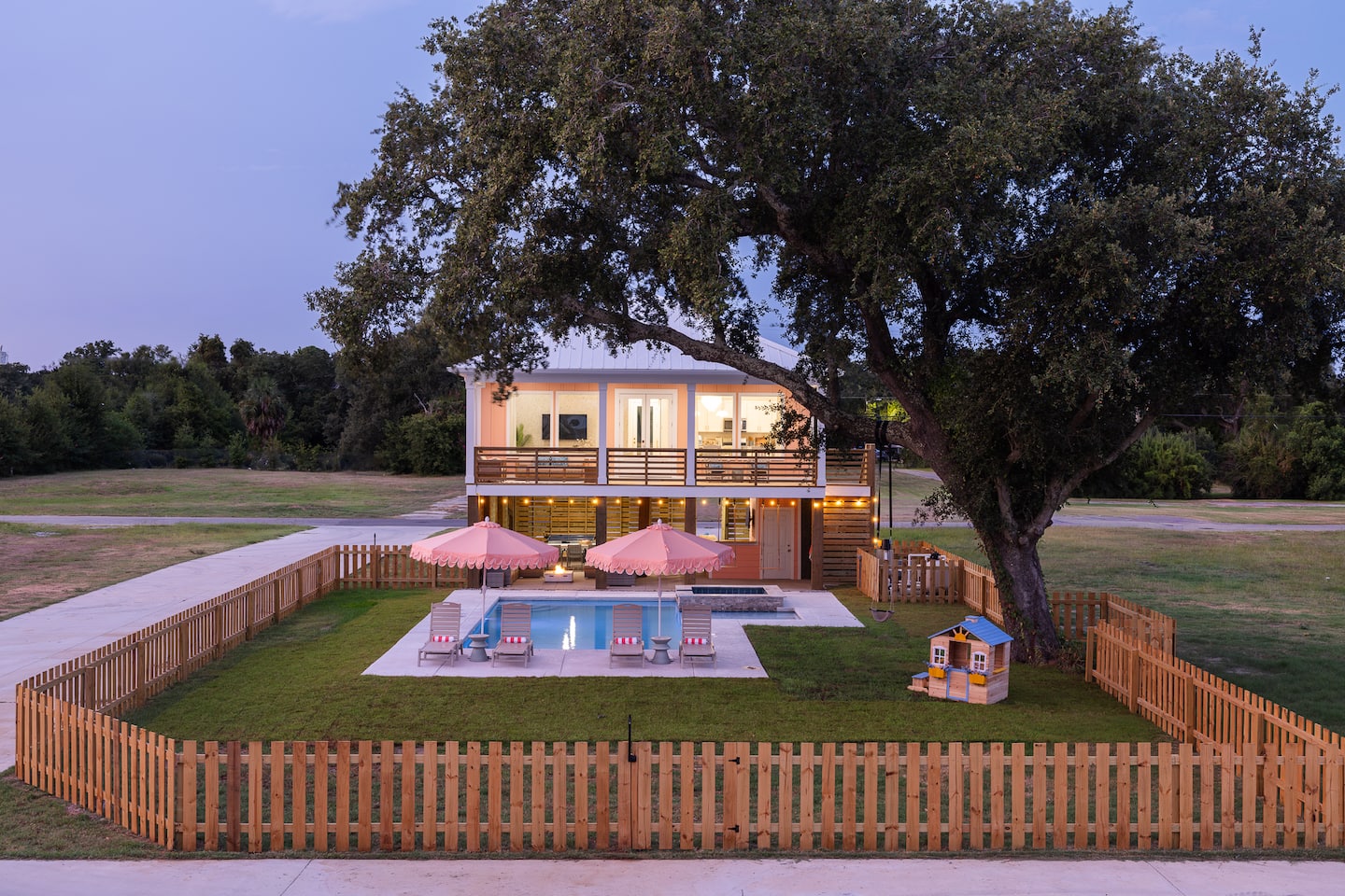 Pool and spa at twilight with the home lit up behind them